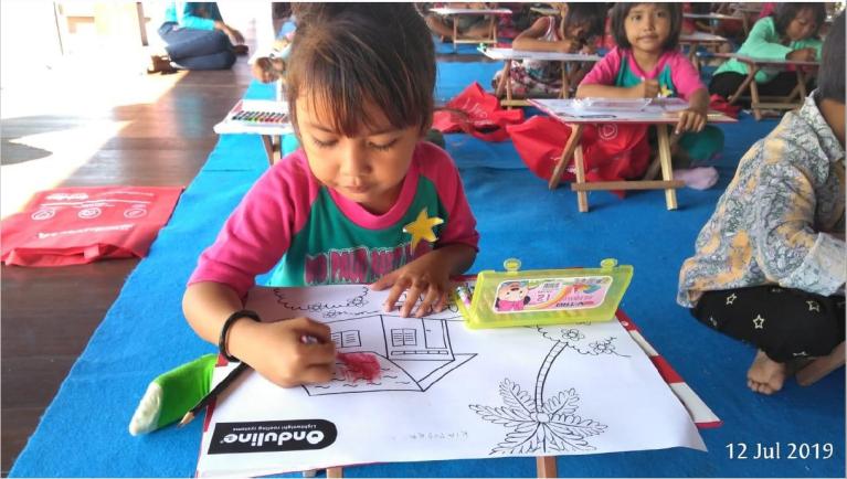 Little girl drawing a roof on her ideal house  